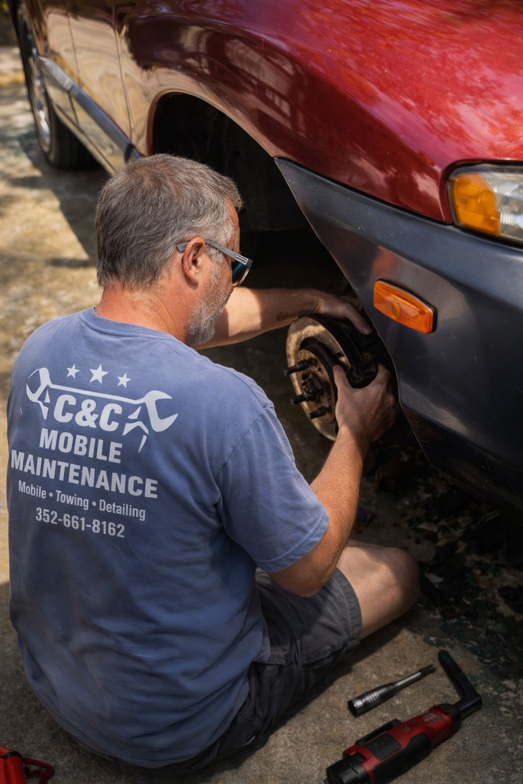 C&C technician in a branded shirt replacing front brakes on-site